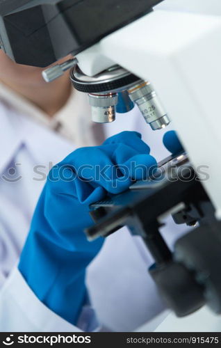 Scientists are using microscopes. For laboratory experiments