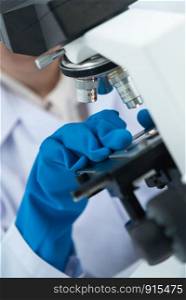 Scientists are using microscopes. For laboratory experiments