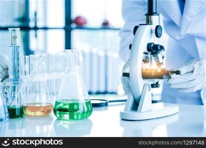Scientists use a microscope Check for germs,Scientist with equipment and science experiments,Germ experts are working and testing in the lab.
