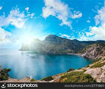 "Scintillate sea surface and evening summer rocky coastline ("Novyj Svit" reserve, "Rhinoceros" cape, Crimea, Ukraine). Six shots stitch image."