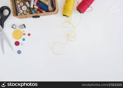 scissor buttons thimble red yellow yarn isolated white background