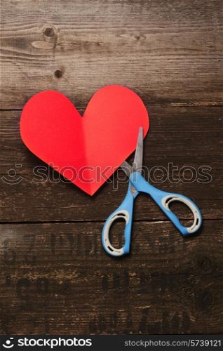 scissors, and the heart of the paper on a dark wooden background.Valentine&#39;s day