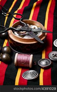 Scissors ,iron, stylish old-fashioned buttons and thread