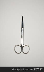 Scissors on gray background.