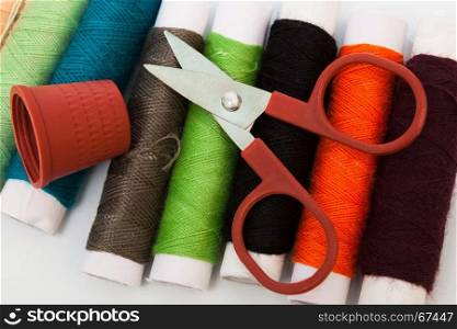 scissors, thimble, thread and colorful close up