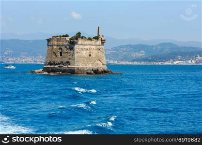 Scola Tower (tower of St. John the Baptist) - is a former military building just near Palmaria island in Portovenere, in the Gulf of Poets (La Spezia, Liguria, Italy). View from excursian ship. People unrecognizable.