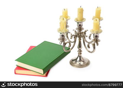 sconce with candles and books isolated on white background