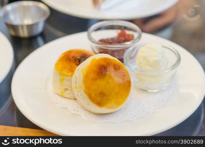 scones . delicious scones on a plate served with cream and jam