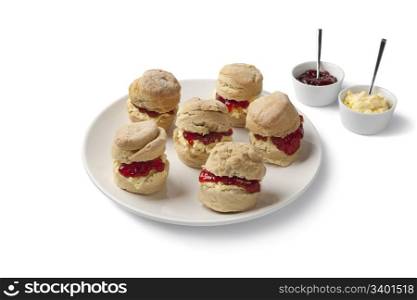 Scones with clotted cream and jam on white background