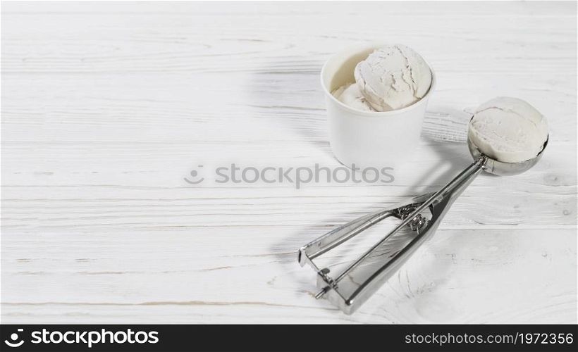 scoop with ice cream ball near cup. High resolution photo. scoop with ice cream ball near cup. High quality photo