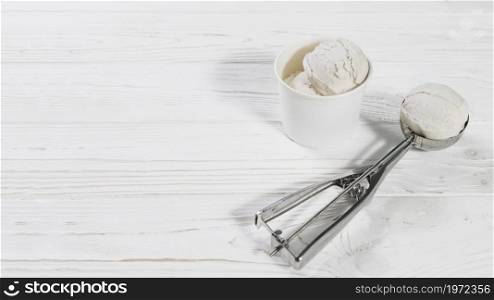 scoop with ice cream ball near cup. High resolution photo. scoop with ice cream ball near cup. High quality photo