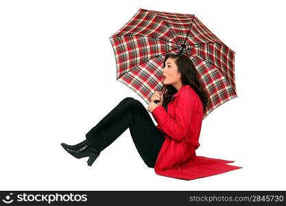 Scottish woman sitting with umbrellas