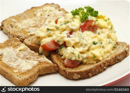 Scrambled egg on whole-grain toast with parsley and cherry tomatoes,