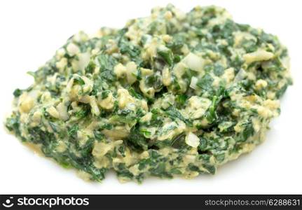 Scrambled egg with spinach, onion and basil. Italian style uova strapazzate al verde, on a white plate.