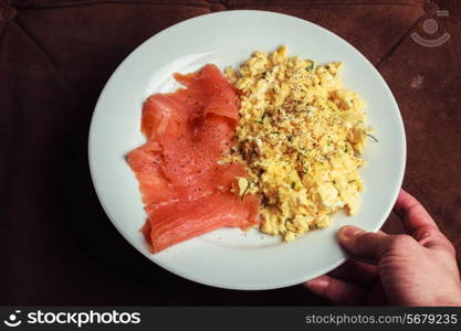 Scrambled eggs and salmon on a white plate