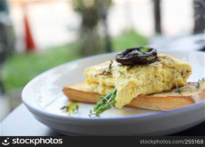 Scrambled eggs with bread asparagus and mushroom in close up