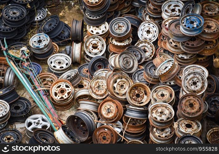 scrap metal / heap of old rusty metal wheel rims in the car dum wheel vehicle waste