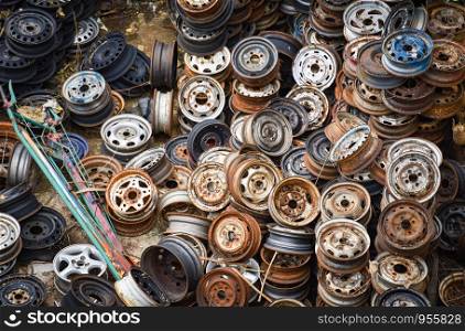 scrap metal / heap of old rusty metal wheel rims in the car dum wheel vehicle waste