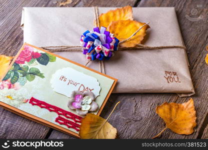 scrapbook background. gift and a card on a wooden table