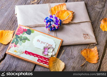 scrapbook background. gift and a card on a wooden table