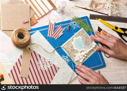scrapbook background. Girl make christmas postcard from buttons and tools with decoration