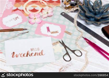 scrapbook background. hello weekend - process of creating a postcard. Card and tools with decoration