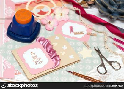 scrapbook background. process of creating a postcard - Card and tools with decoration