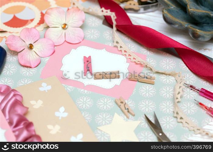 scrapbook background. process of creating a postcard - Card and tools with decoration
