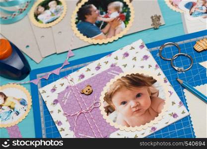 scrapbook background. the process of creating a childrens album. Card and tools with decoration
