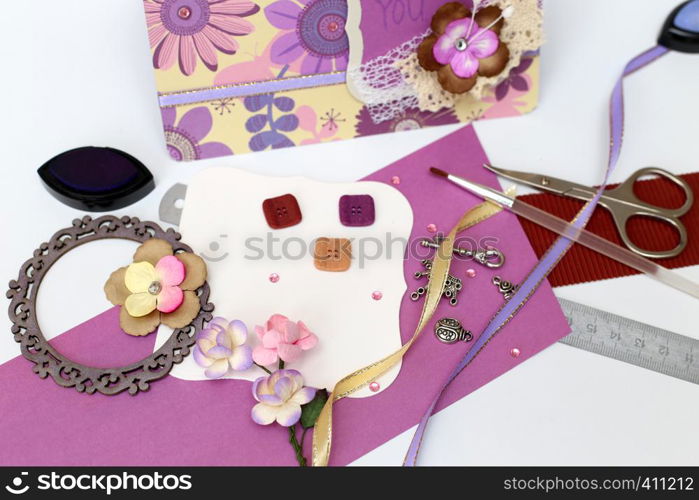 scrapbook. Card and tools with decoration on white background