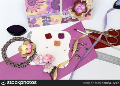 scrapbook. Card and tools with decoration on white background