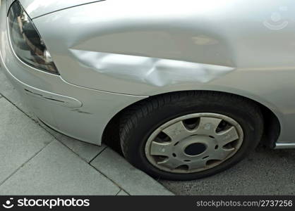 Scraped and crushed car fender