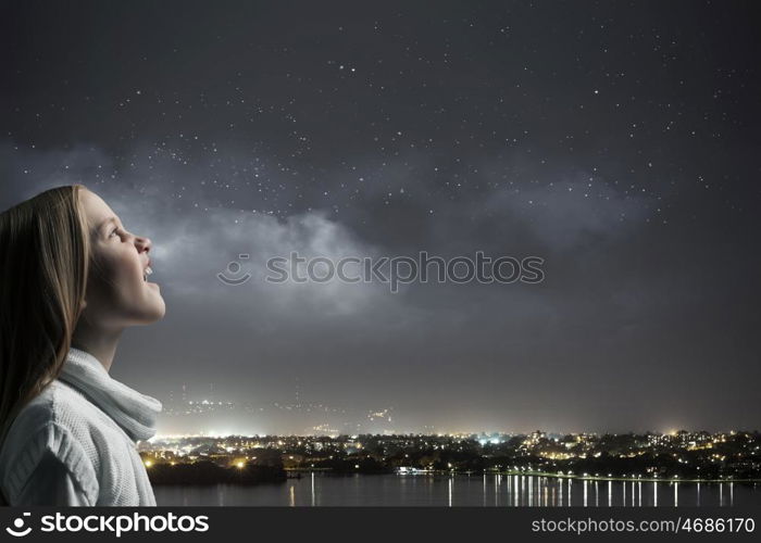 Screaming girl. Side view of cute screaming girl against dark background