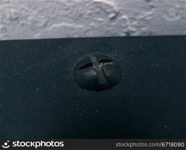 screw head in a dark blue surface