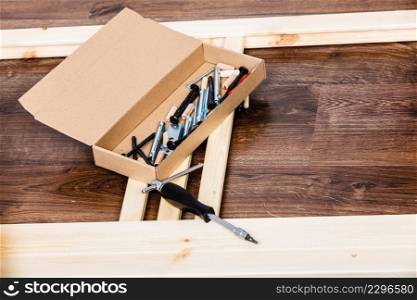 Screwdriver and nails for furniture assembling. DIY home improvement.. Screwdriver and nails for furniture assembling.