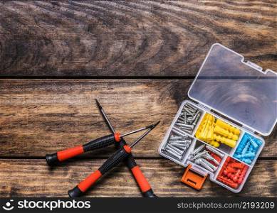 screwdrivers with bolt kit wooden background