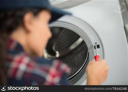 screwing the cover of the washing machine