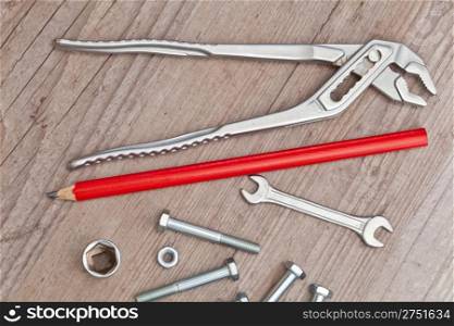 screws and bolts tools for carpentry on wooden background