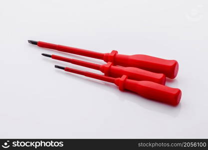 Screws and screwdriver isolated on white background. Long nasal and diagonal cutters.. Screws and screwdriver isolated on white background.