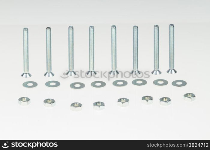 Screws, nuts, and bolts on isolated white background
