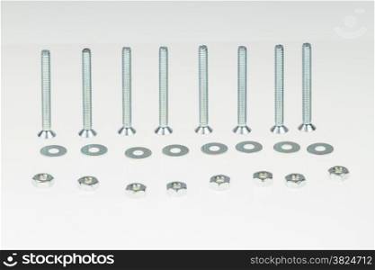 Screws, nuts, and bolts on isolated white background
