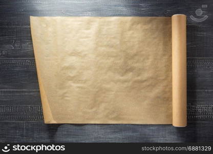 scroll of brown paper at wooden background texture