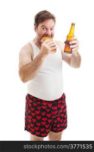 Scruffy, overweight middle aged man in his underwear, eating a submarine sandwich and drinking a beer. Isolated on white.