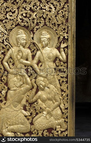 Sculpture carved on door of temple, Wat Xieng Thong temple, Luang Prabang, Laos