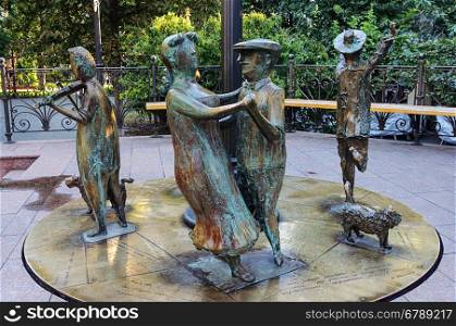 Sculpture of dancing people in City Garden of Odessa, Ukraine