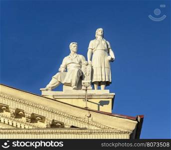 Sculpture of man and women on the roof of Trade Union Palace in Minsk, Belarus. Stalin's era style.