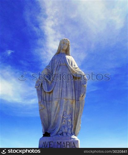 sculpture of snow virgin on the top of the Andes with blue sky