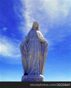 sculpture of snow virgin on the top of the Andes with blue sky