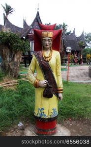 Sculpture of woman in traditional clothes near palace in Bukittingi, Indonesia