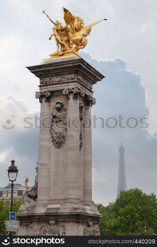 Sculpture on Alexandre III bridge. Pont Alexandre III is an arch famous bridge that spans Seine, connecting Champs-Elysees quarter and Invalides. It is a historical monument. Paris, France.. Sculpture on Alexandre III bridge